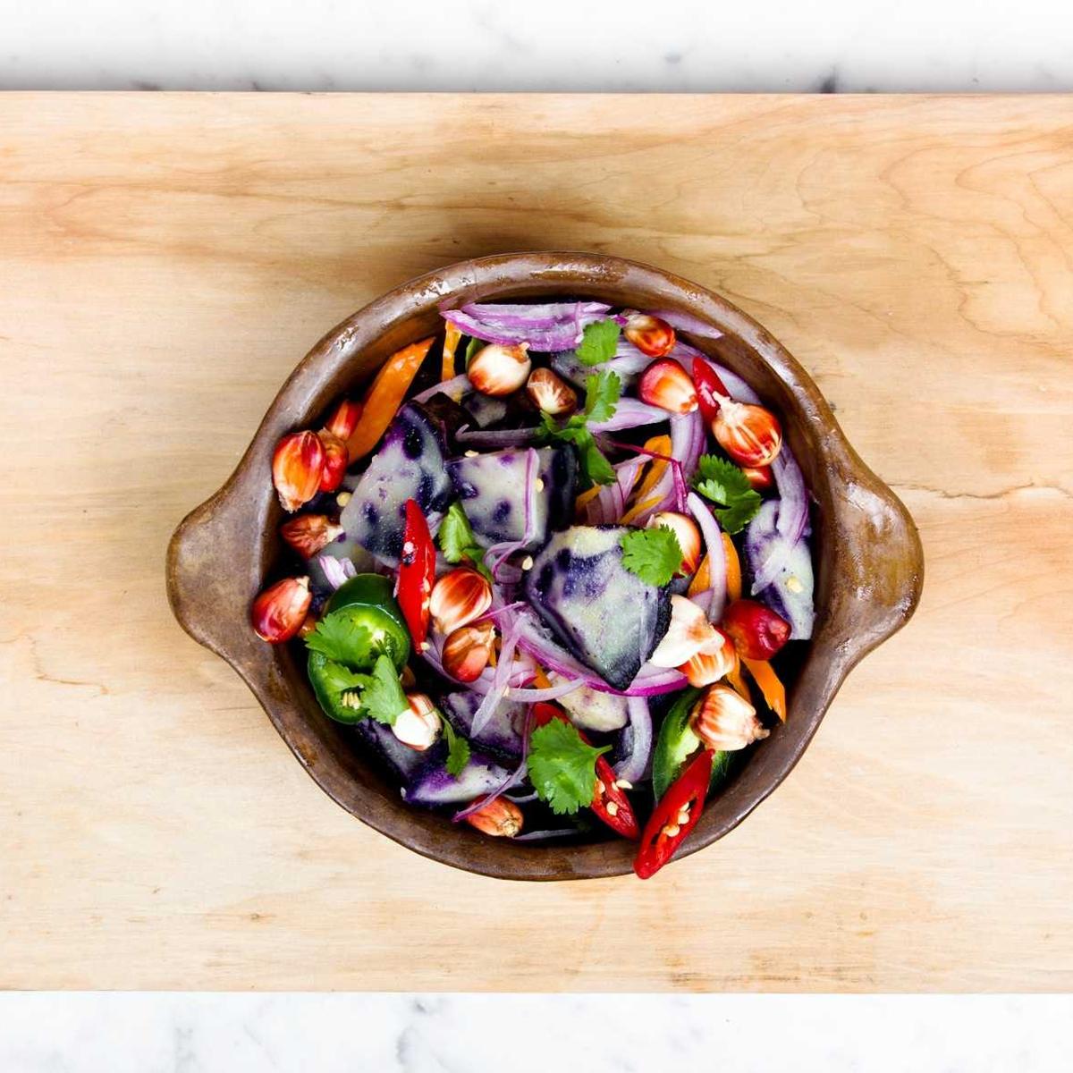 A shared dish on a wooden board